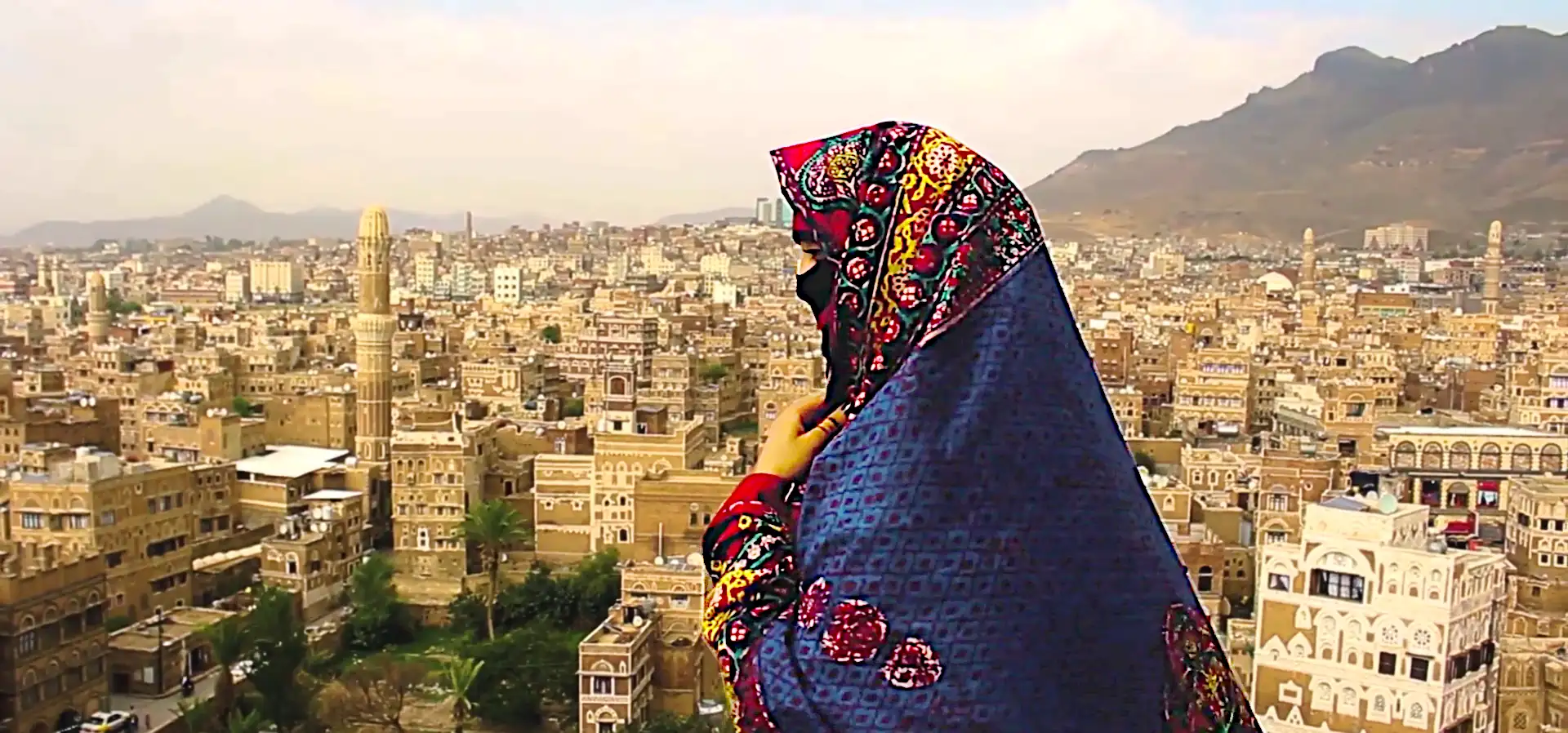 A Libyan woman. In the background is the capital city of Libya